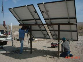 Worker's setting up Solar Panel Array